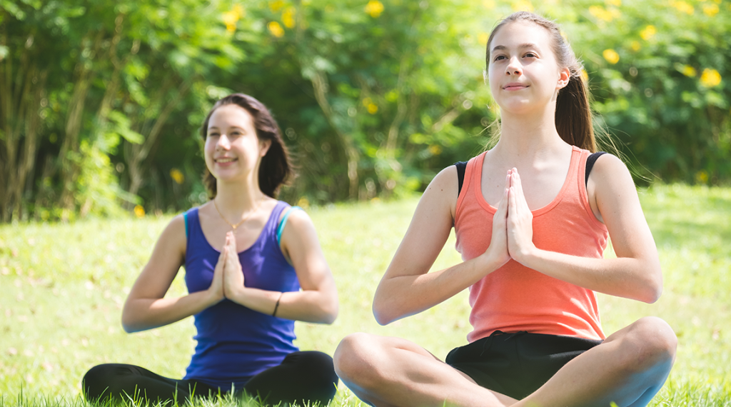 Girls doing yoga as part of teen ocd treatment in California