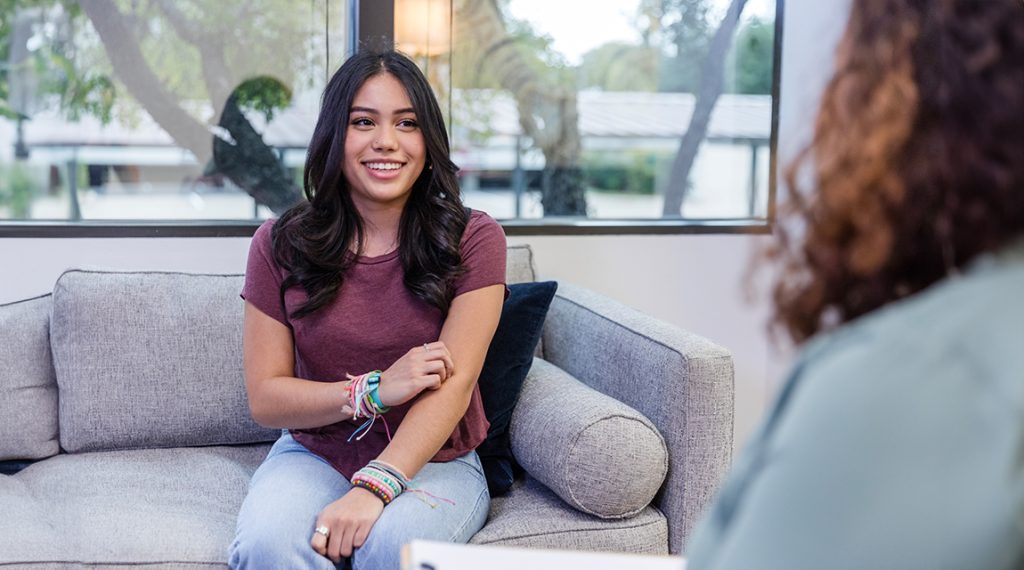 Teen girl smiling in counseling session