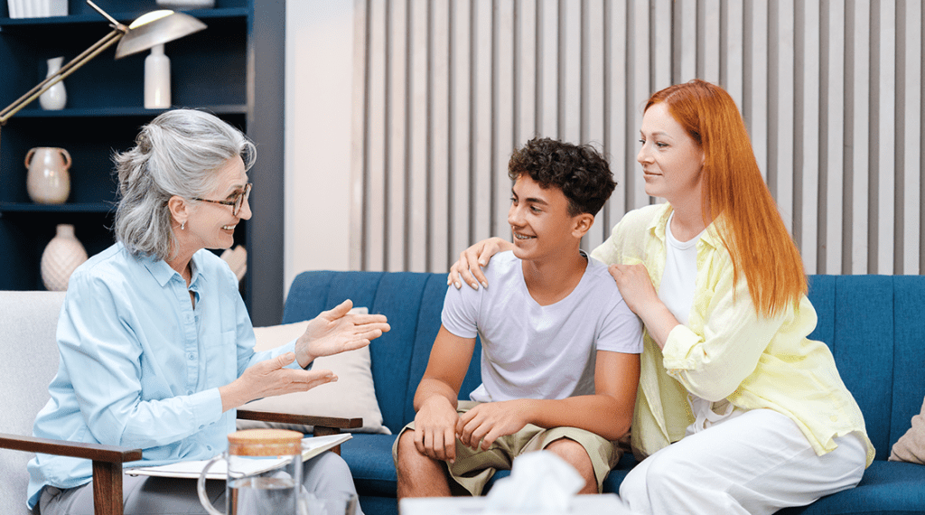 Family therapy session with teen boy and mom..