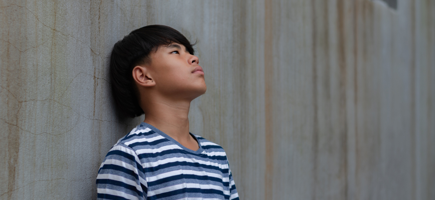 Sad teen Asian boy