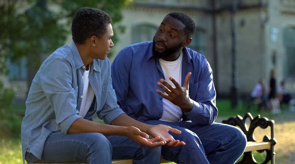 Father and son communicating about how to prevent verbally abusive behavior