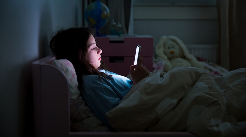 Child using social media at night - parents can monitor teen social media use to improve sleep