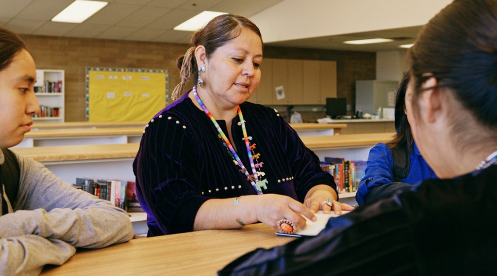 Indigenous teens with a guidance counselor 