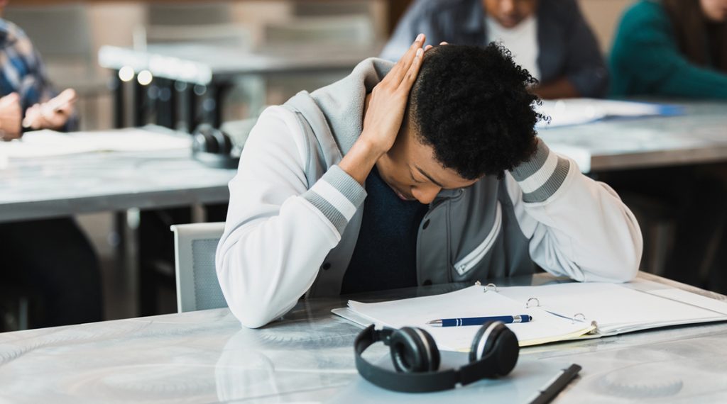 Teen moodiness in a teen boy at school